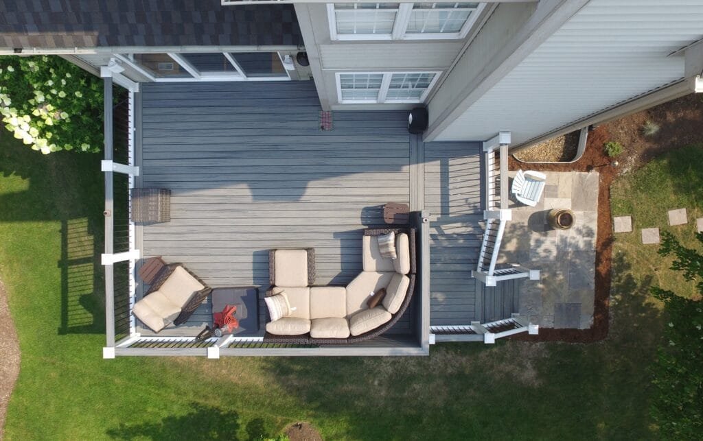 Aerial view of new Trex Pebble Grey composite deck with outdoor lounge area by your local deck builder Warner's Decking in Plainfield IL.