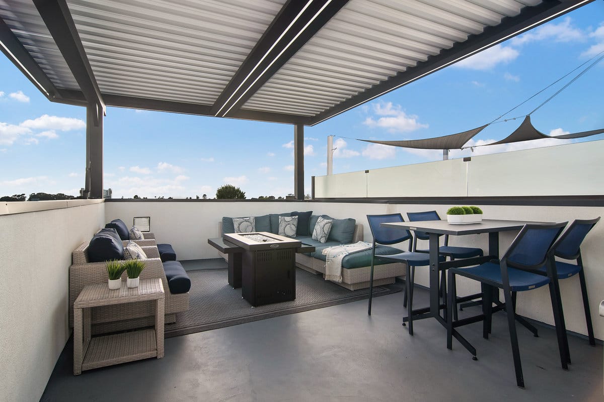 Motorized louvered pergola with adjustable roof slats and integrated lighting for outdoor living.