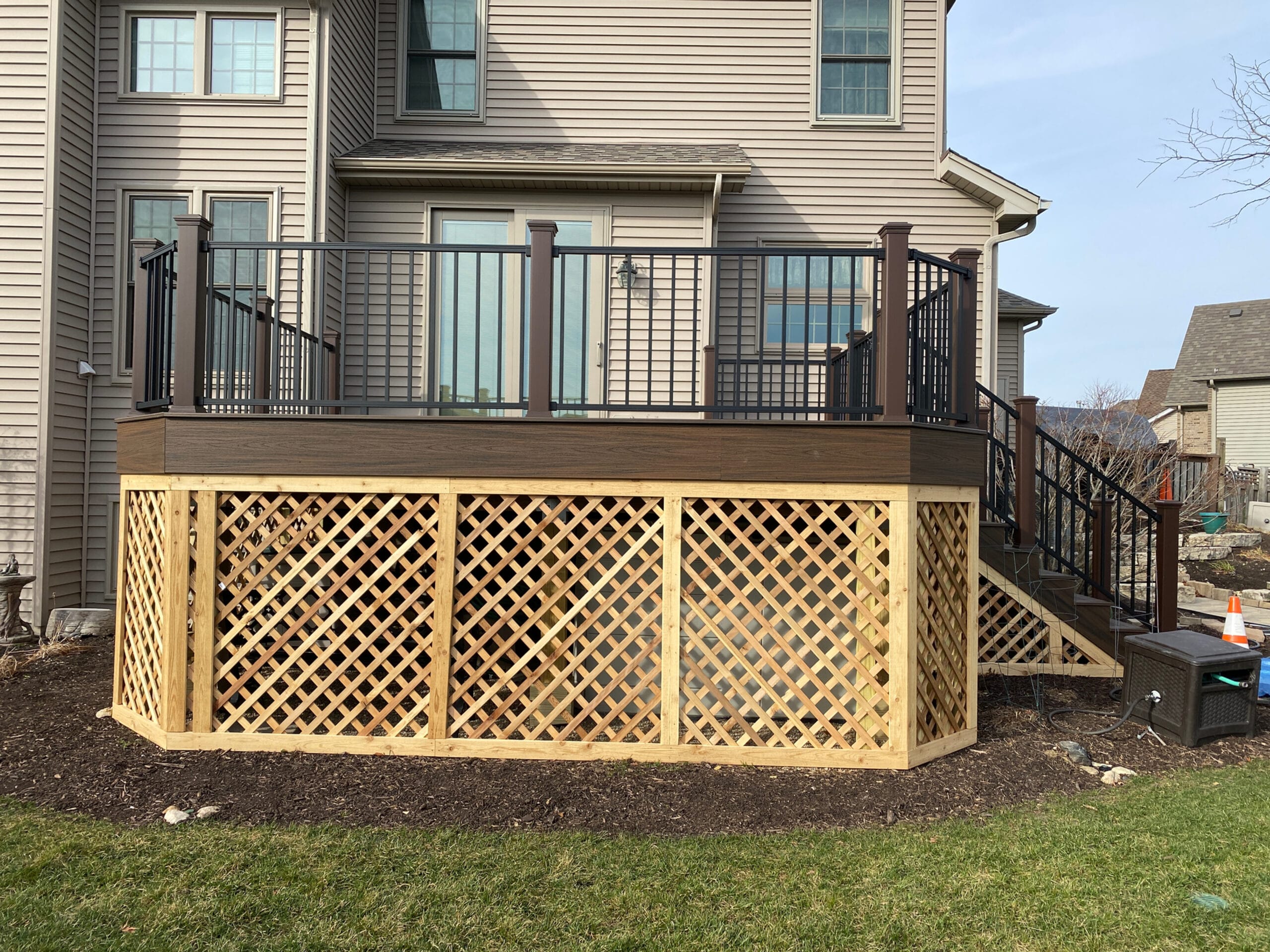 Wood lattice deck skirting with a Trex composite deck.
