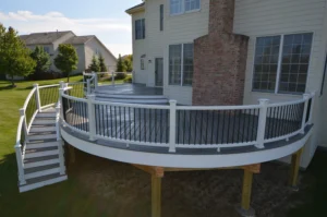 Curved trex deck with white railing system.