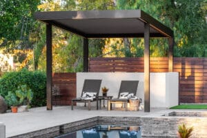 Aluminum louvered pergola with adjustable closed slats and integrated lighting by the pool