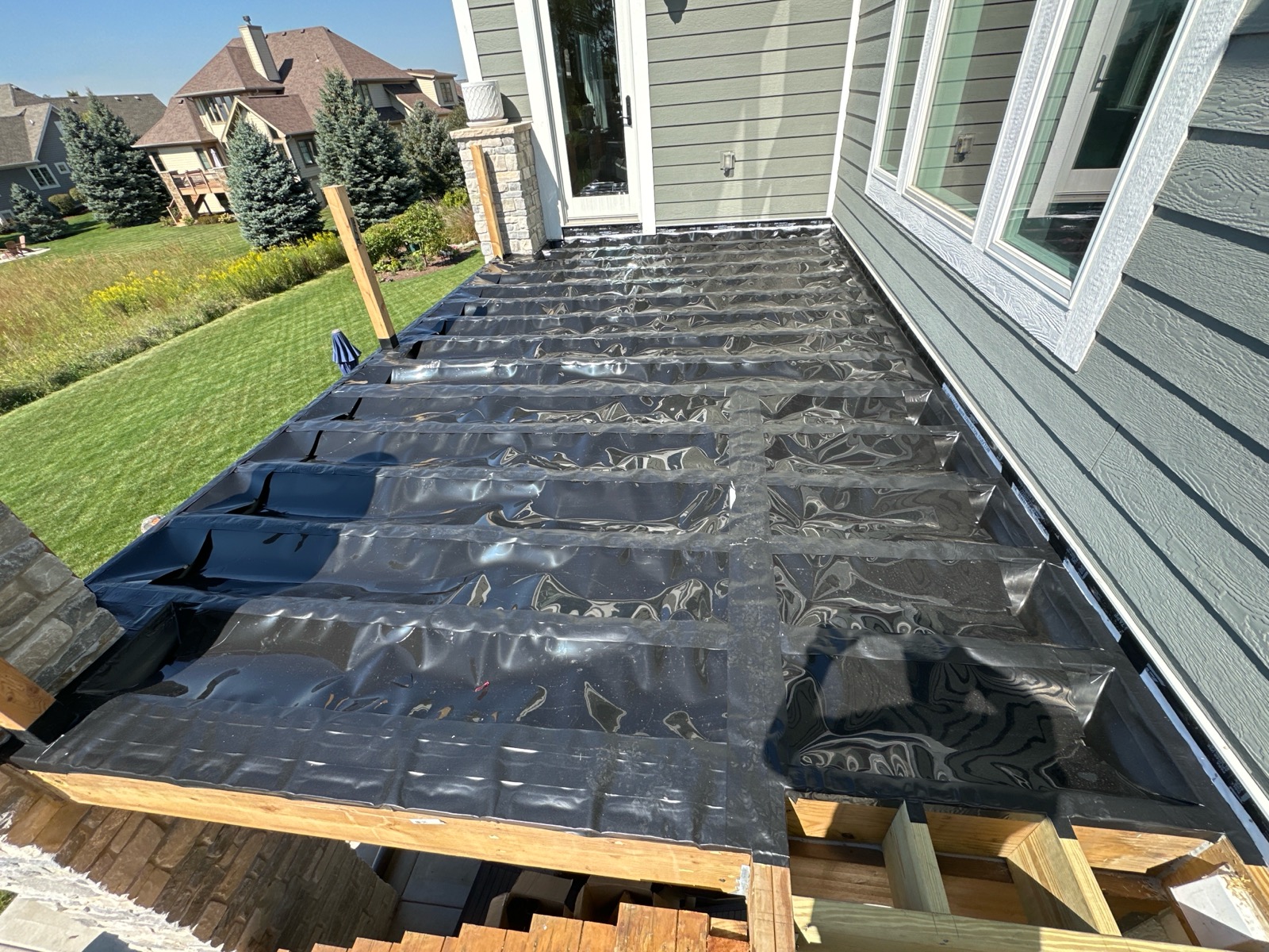 trex-rainscape-deck-installation-plainfield-il Trex RainEscape under-deck drainage system before board installation in Plainfield IL