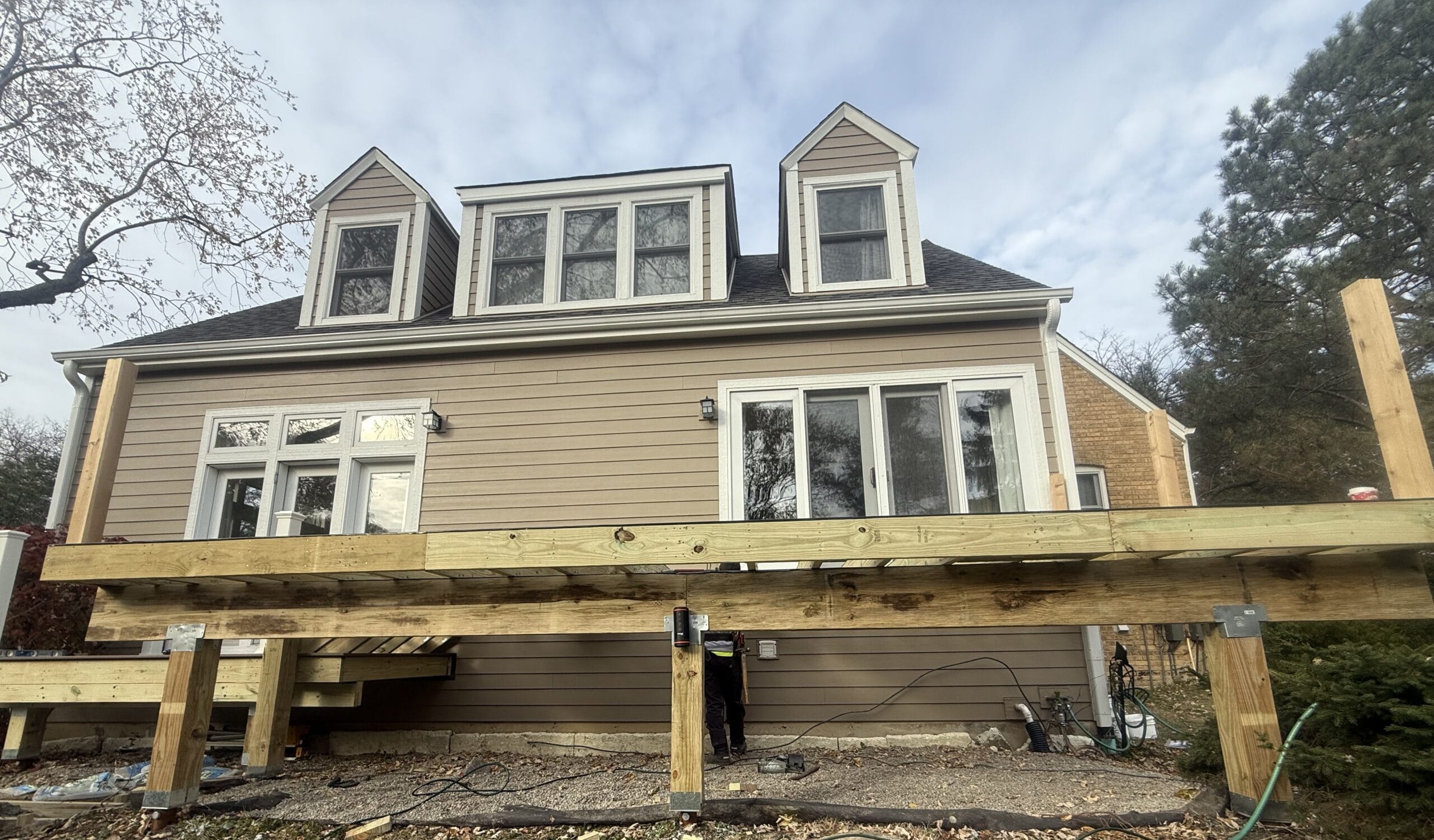 Deck substructure showing helical piers installed for stable foundation support.