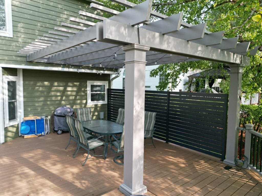 Pergola by the pool deck creating a relaxing outdoor lounge area in Chicago area.