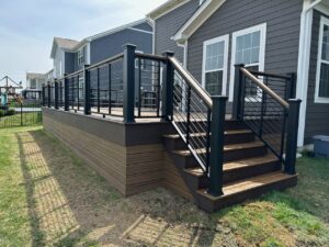 Backyard Trex composite deck with steps down to a patio in Naperville, Illinois