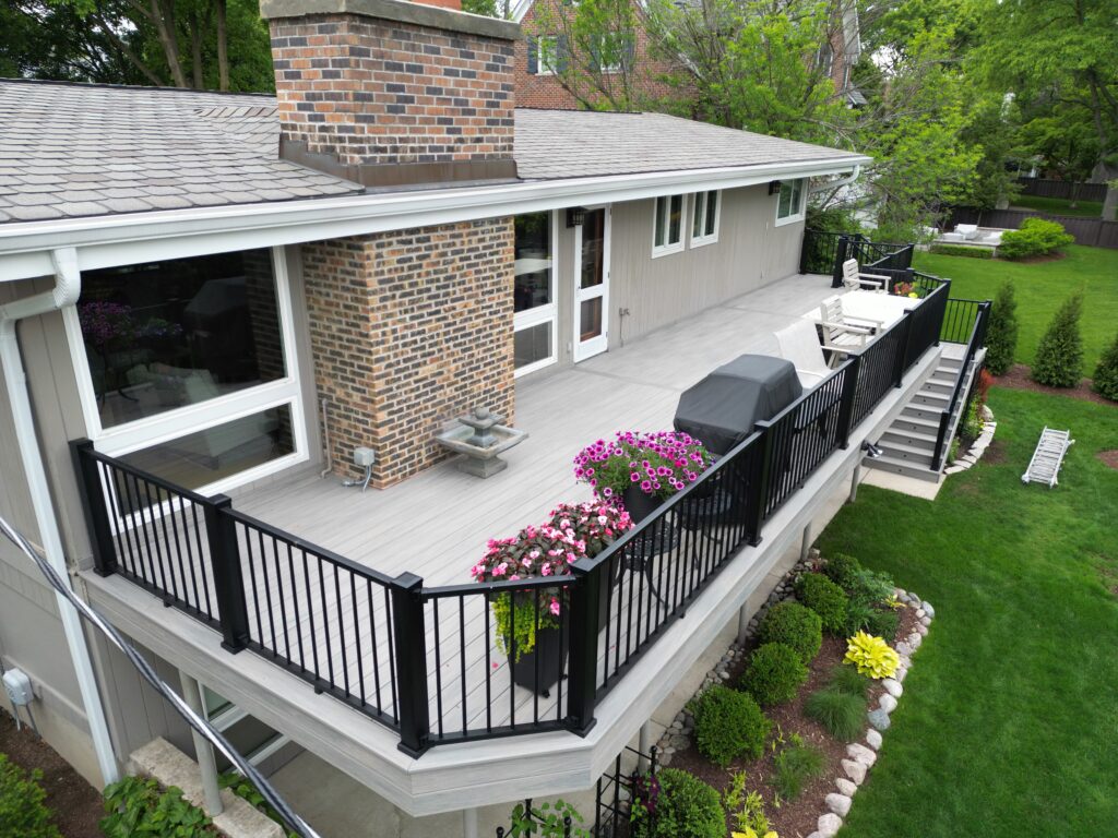 Custom grey Trex composite deck installed in Plainfield with black railings.