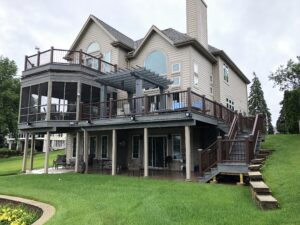 Multi-level deck with a screen room and balcony.