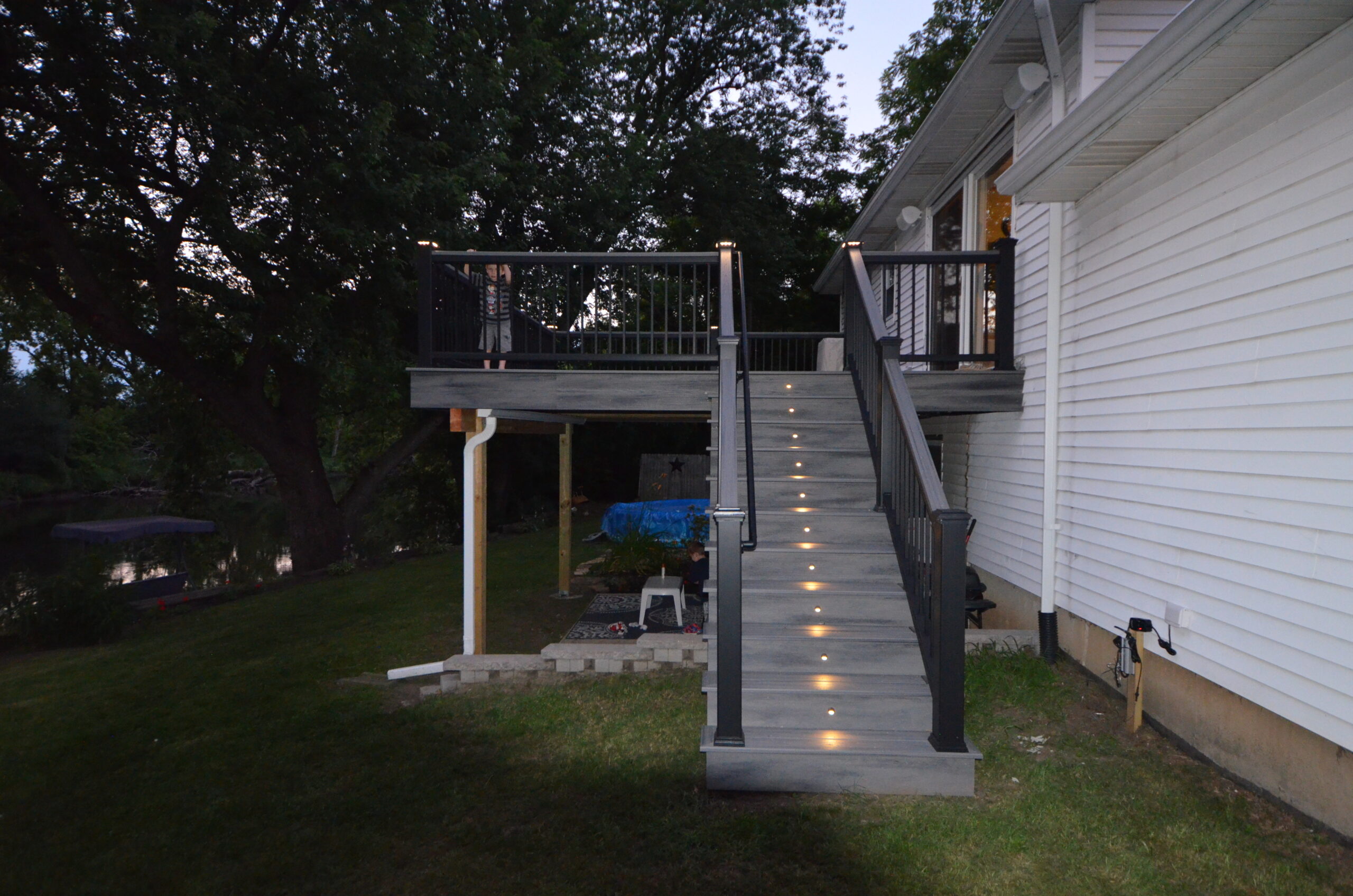Trex Transcends Island Mist Decking Fascia and Risers with Black Risers lights and LED Black Cap Lights scaled