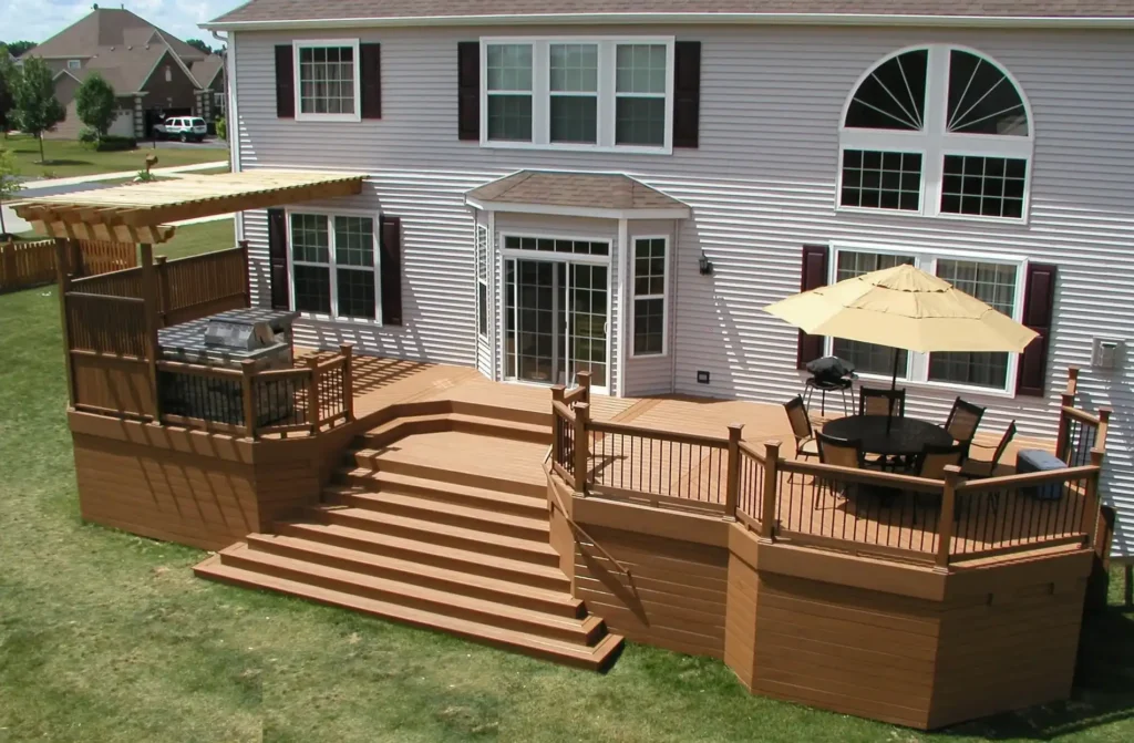 Trex Signature® composite deck with skirting in Ocracoke color, with a dining area, pergola.