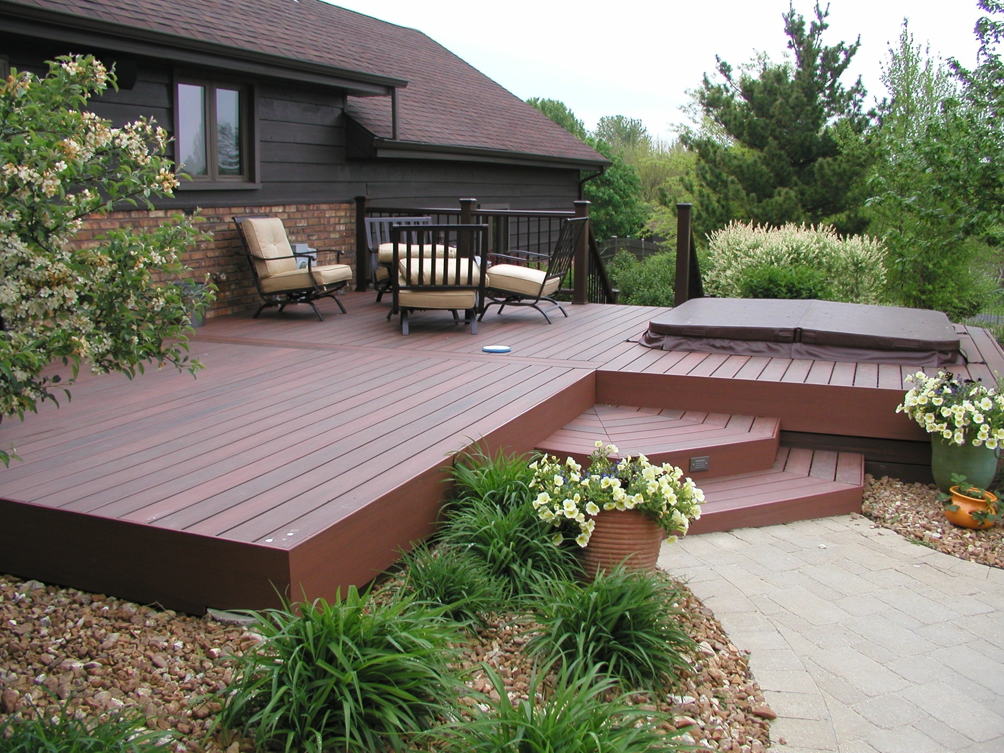 Composite deck integrated with a hottub creating a peaceful environment by professional deck builders in Plainfield, Illinois.