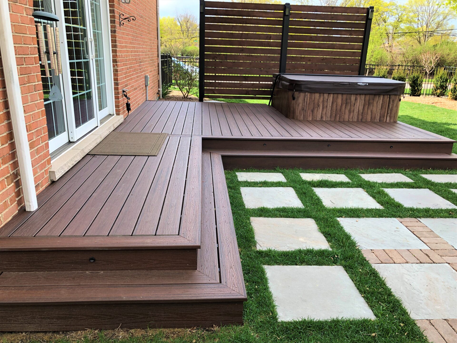 Custom Trex deck installed by certified contractors. Showcasing the beauty and longevity of a composite deck integrated with a hot tub.