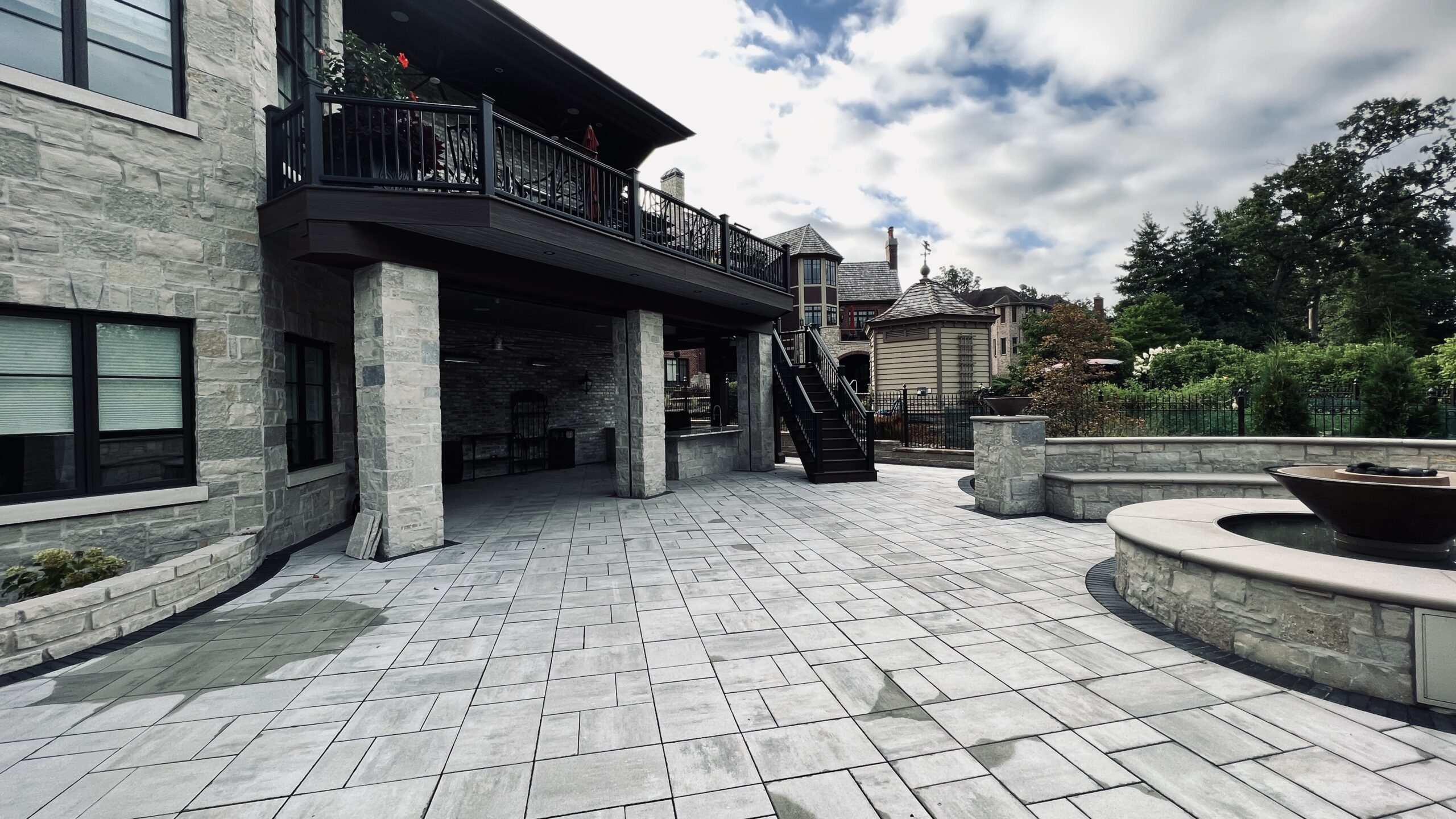 Raised Trex composite deck with Trex RainEscape, creating a dry, functional outdoor kitchen below.