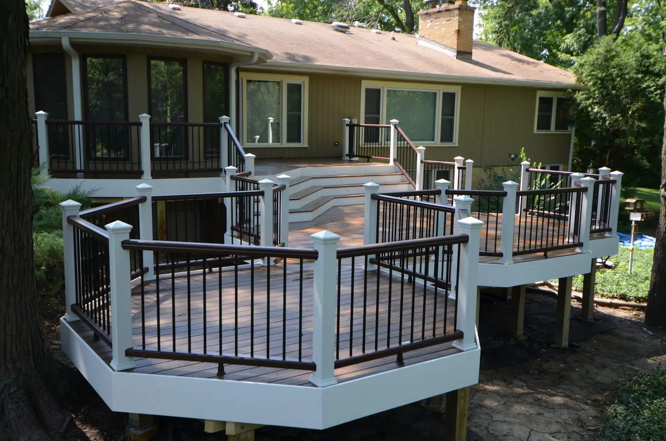Multi-level custom curved Trex composite deck in the Chicago suburbs, IL, featuring elegant curves and tiered design blending with the house.
