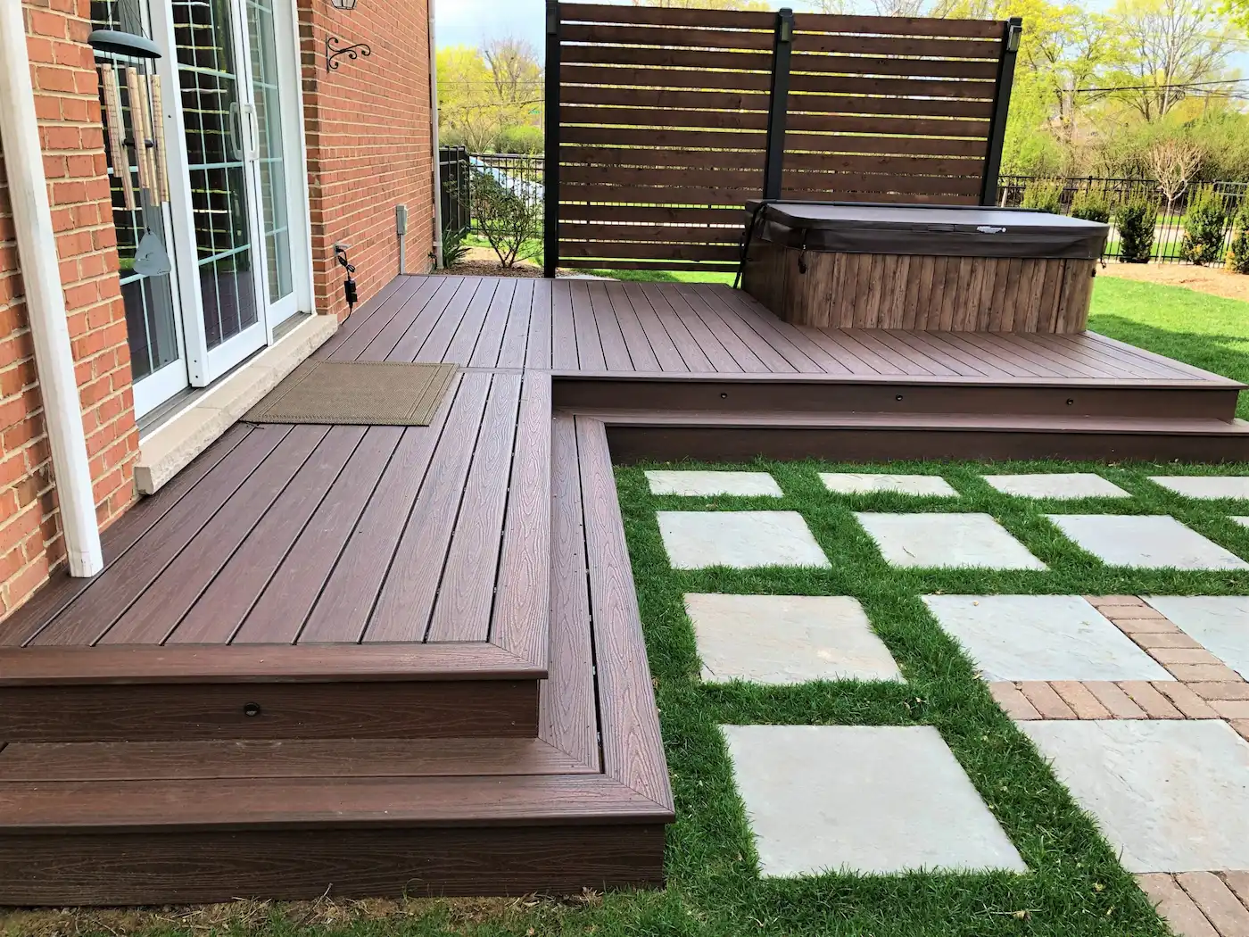 Custom Trex deck installed by certified contractors. Showcasing the beauty and longevity of a composite deck integrated with a hot tub.