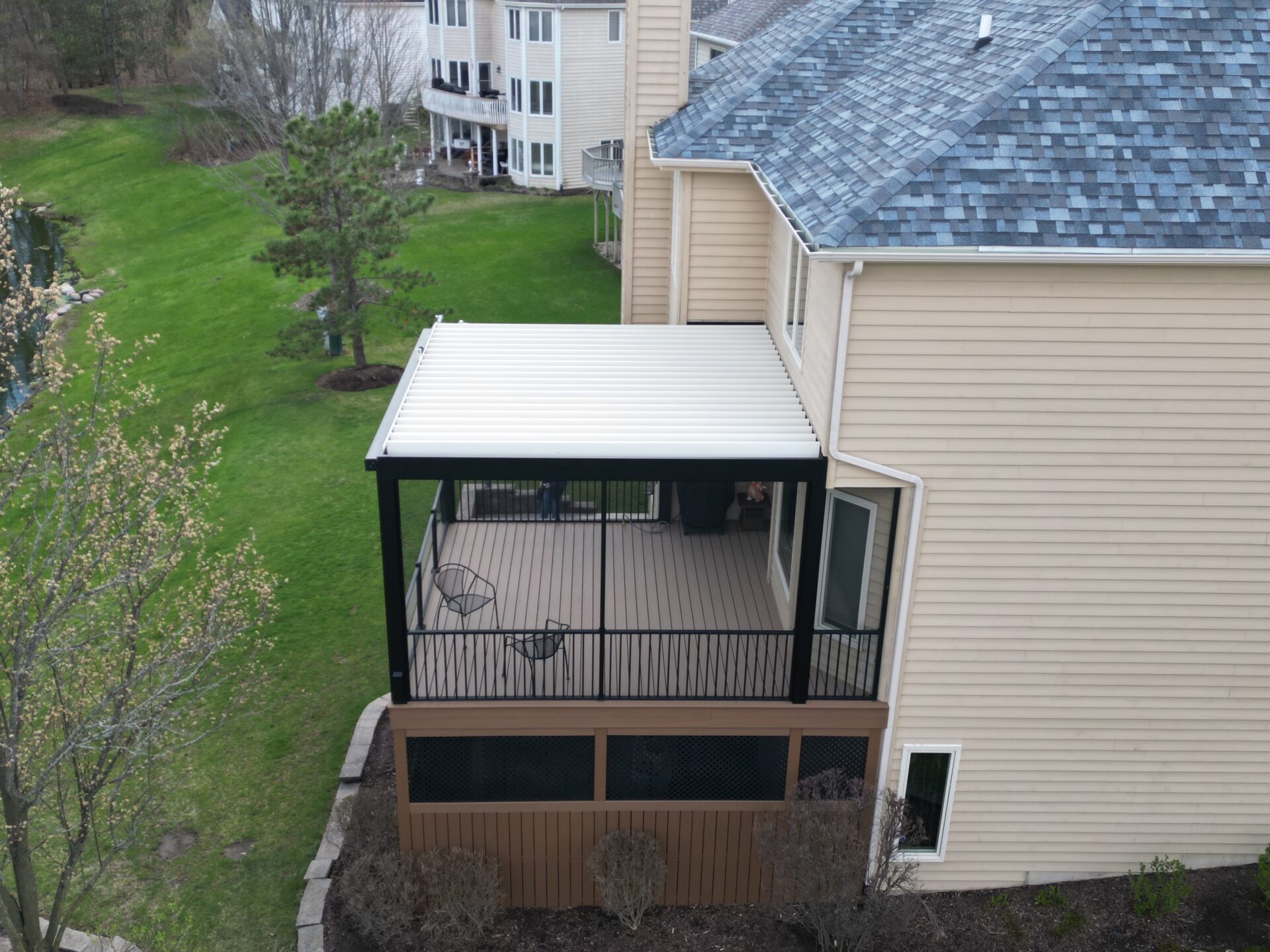louvered roof pergola integrated with a raised trex deck.