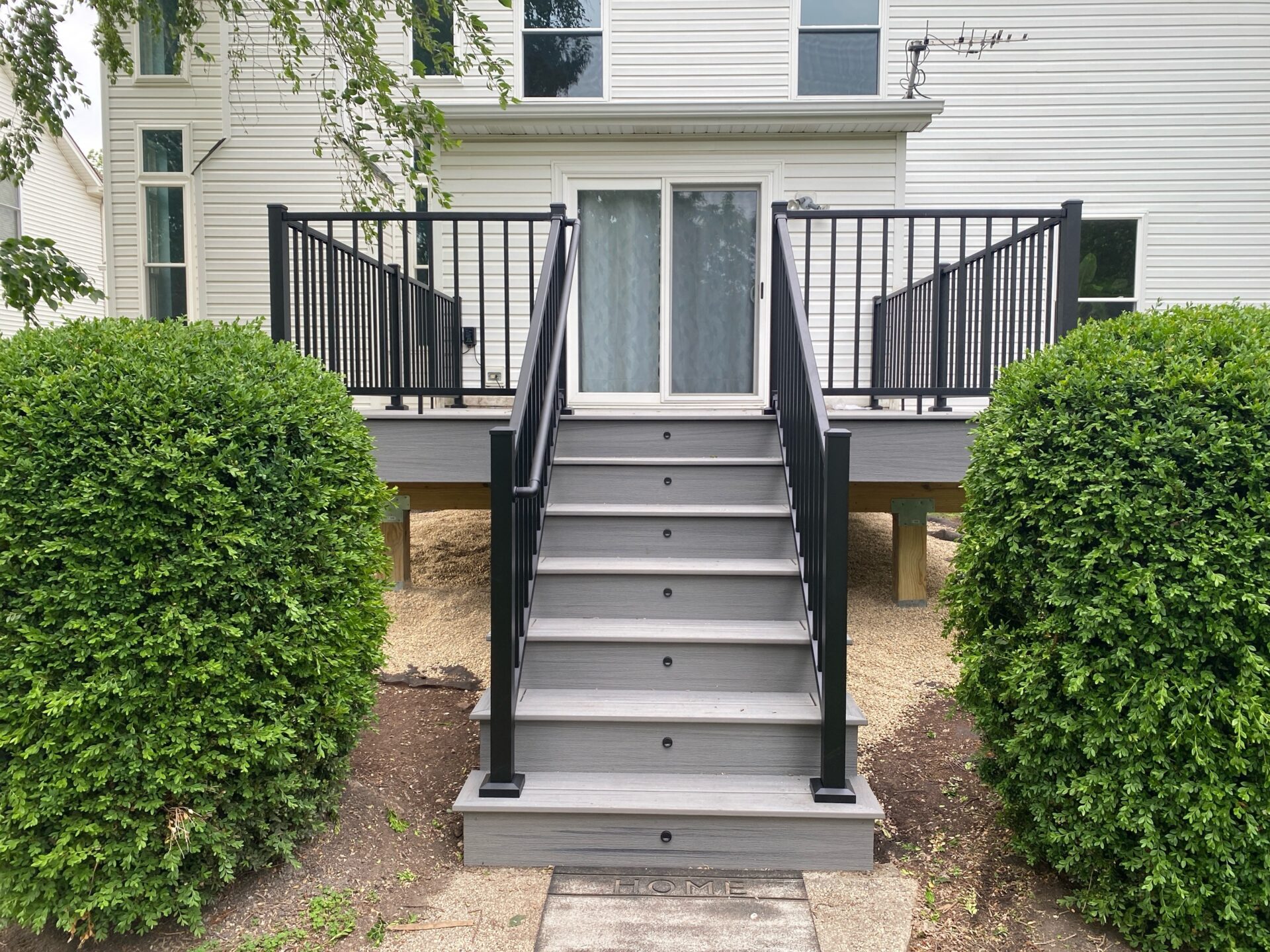 Trex composite deck integrated with stair lighting in Aurora, IL built by Warner's Decking.