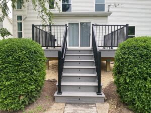 Trex composite deck integrated with stair lighting in Aurora, IL built by Warner's Decking.
