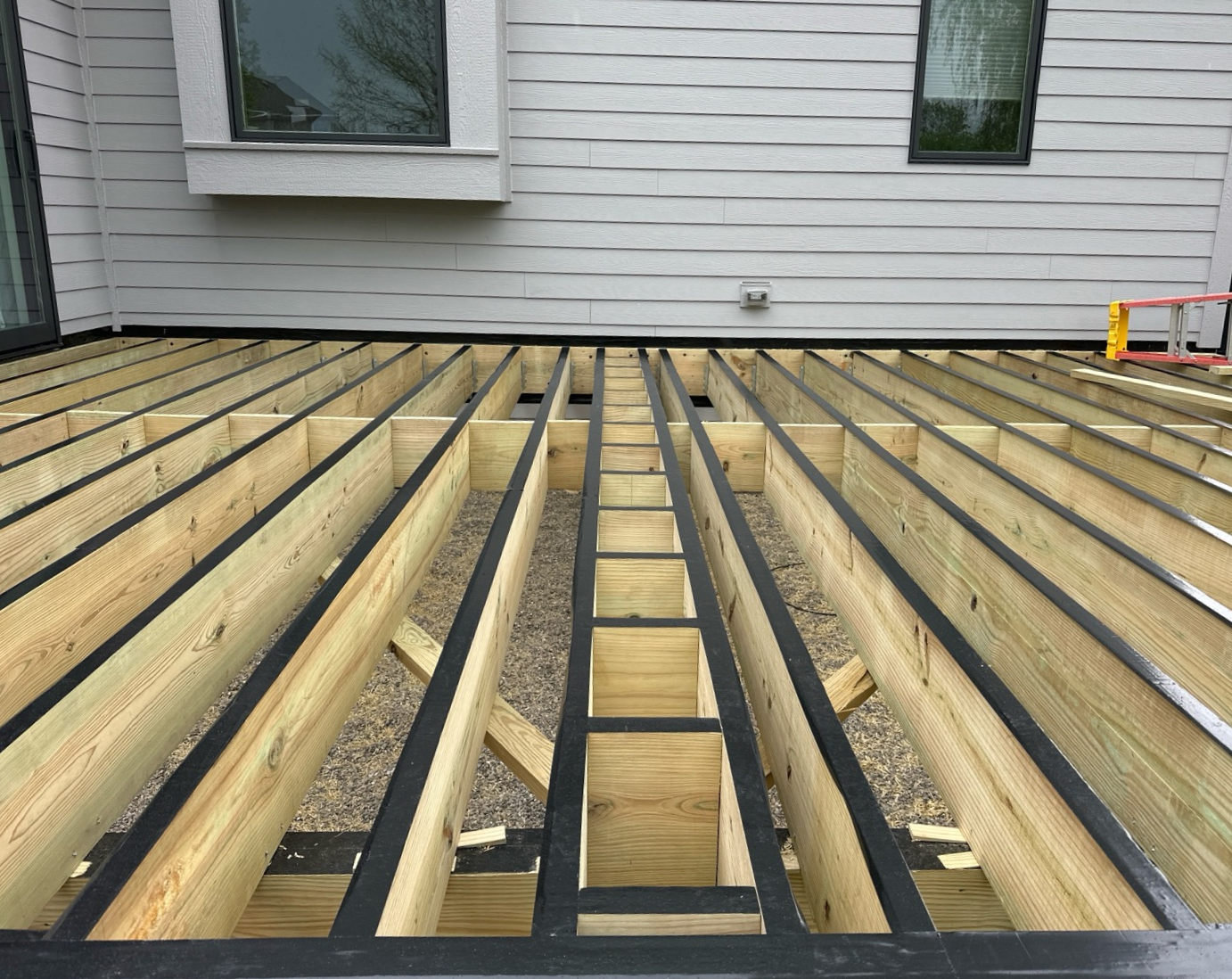 close up view of deck framing covered with joist tape and displaying proper spacing between joist.