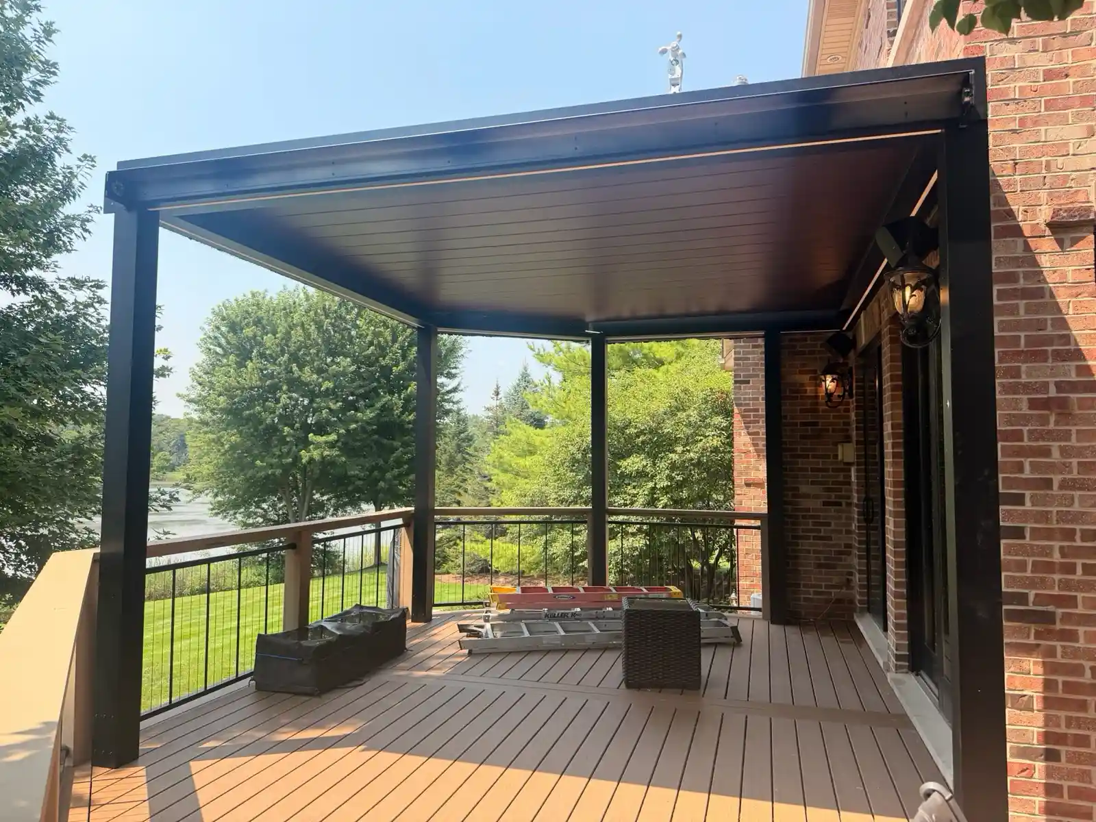 Motorized louvered roof pergola installed on top of a raised composite deck in Plainfield, Illinois.