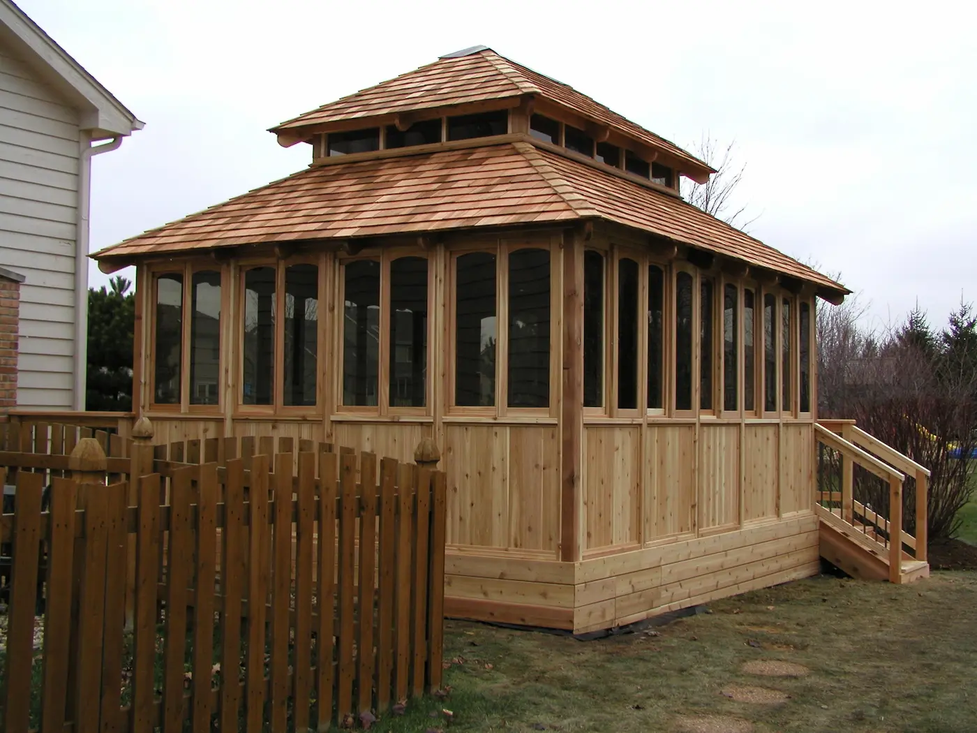 Custom wooden sunroom addition built in a backyard in the Chicago suburbs.
