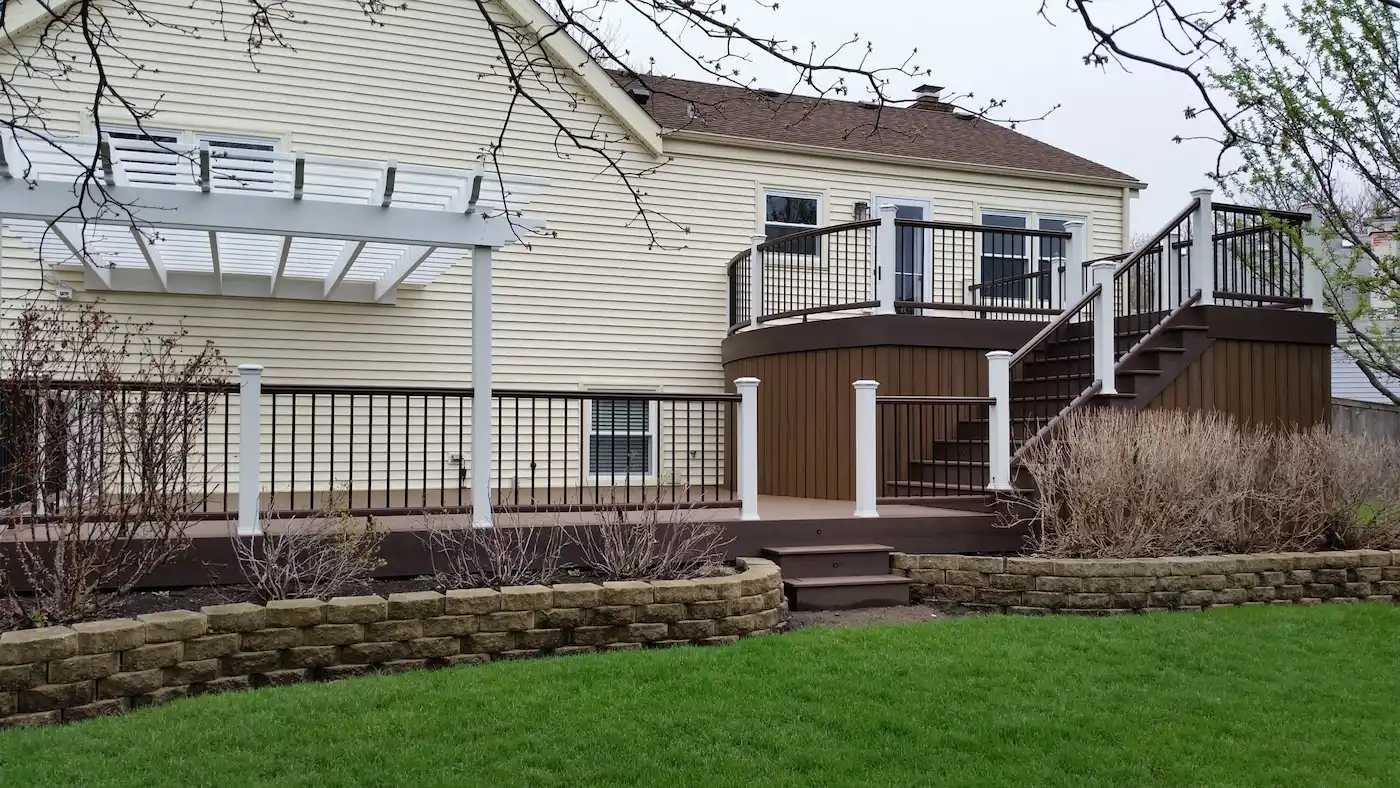 Custom multi-level deck featuring two-tone Trex Transcend composite decking and an attached pergola in Downers Grove, IL