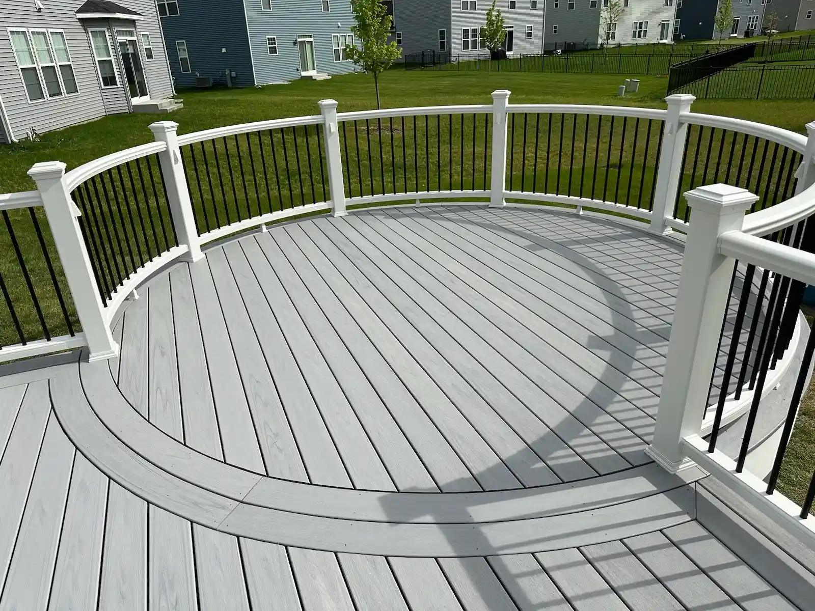 trex-composite-deck-with-curved-design-and-railing-naperville-illinois Curved Trex composite deck with custom design in Naperville, Illinois