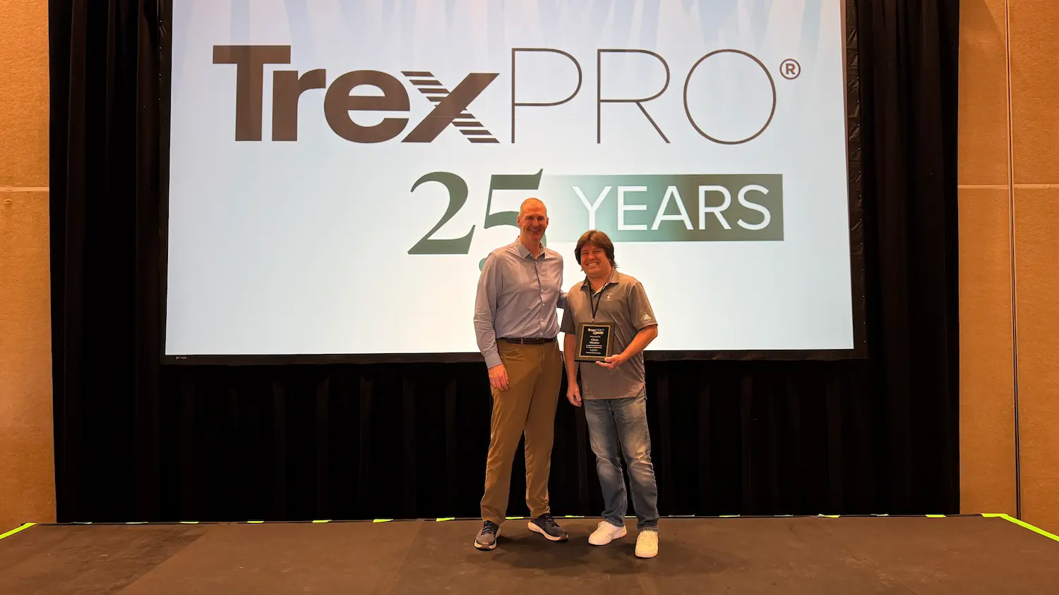 Warner’s Decking CEO with Trex CEO holding a 25-year TrexPro Platinum partnership award