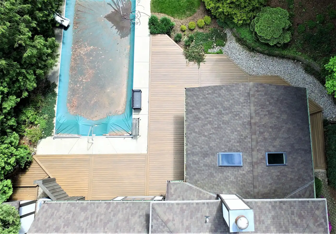 Aerial overview of a newly built wrap-around composite deck with custom pool surround integration in the Downers Grove, IL.