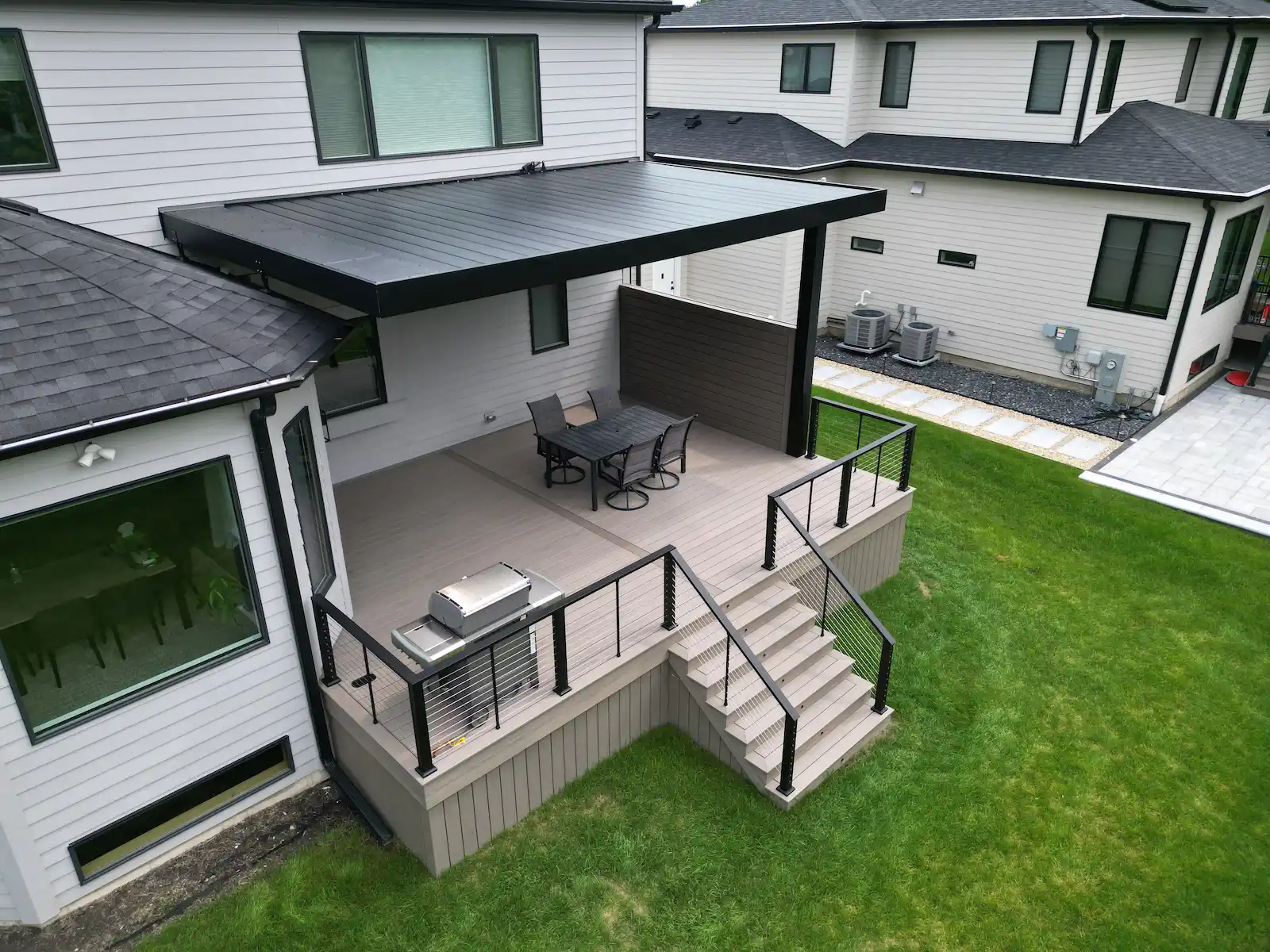 Privacy wall and louvered pergola on composite Trex Transcend Lineage deck in a Naperville, IL backyard